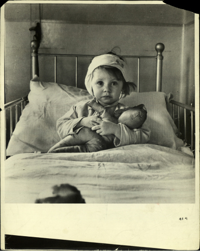 Three-year-old English girl recovering from head injury suffered during a German air raid on her Northern English village.